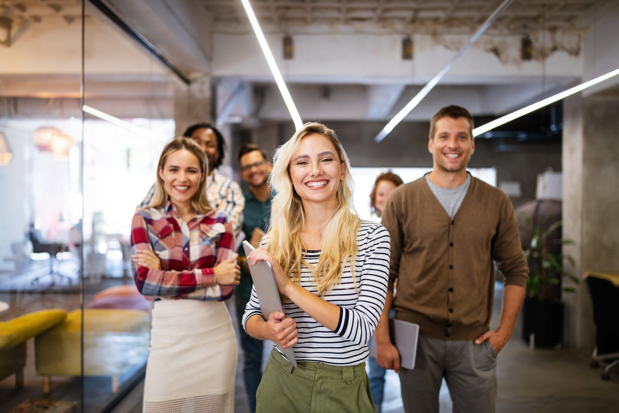 Successful group of designers, business people at work in office